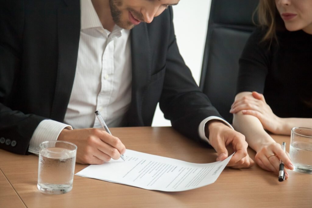 satisfied smiling businessman suit signing contract meeting concept
